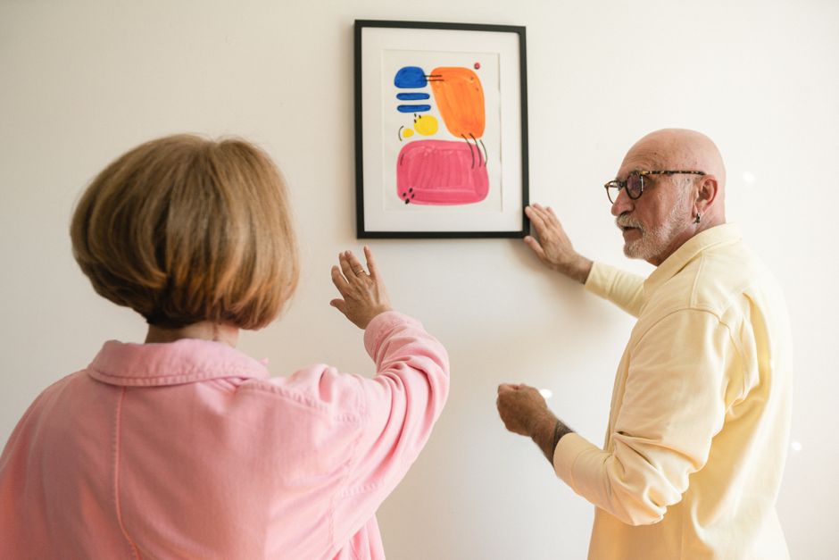 senior citizens looking at painting exhibition