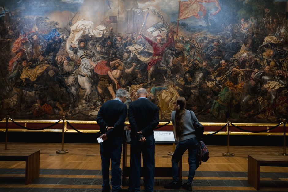museum visitor looking at painting