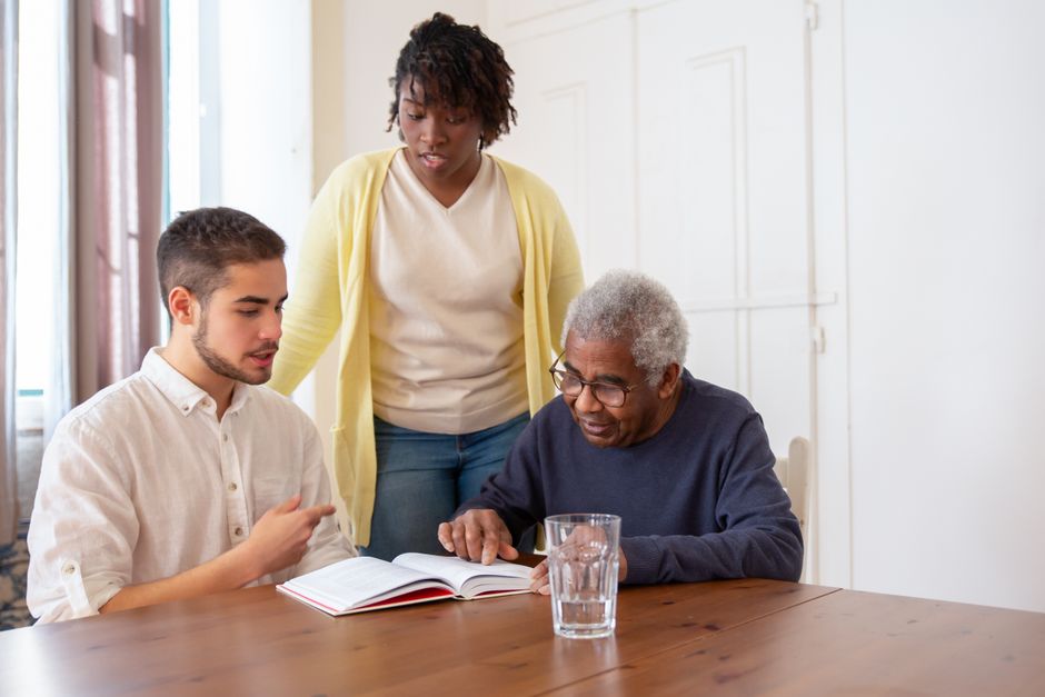 senior citizen reading paperwork with family