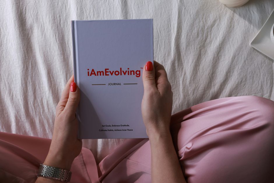 person writing gratitude journal morning