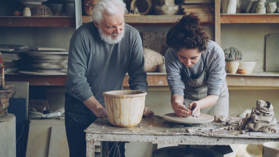 elderly hands teaching craft workshop