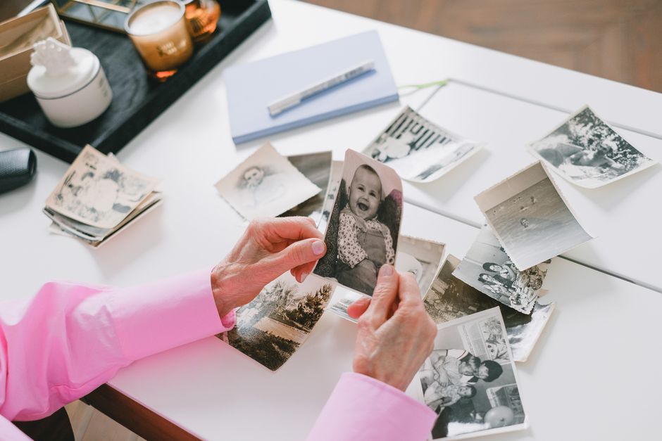 elderly hands sorting old photographs