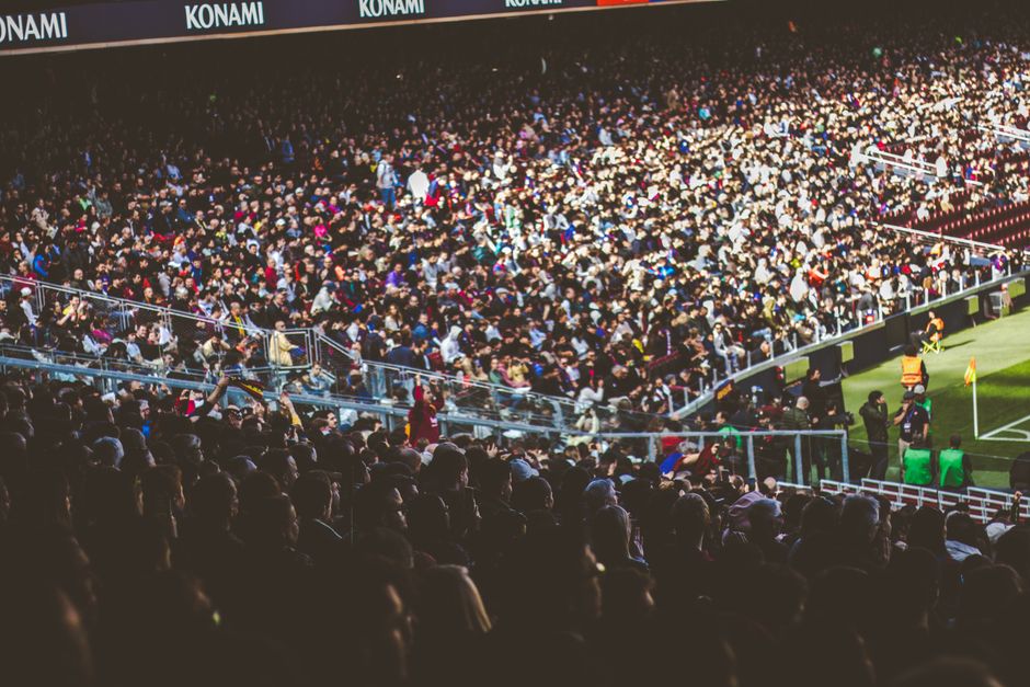 fans eating snacks at sports stadium