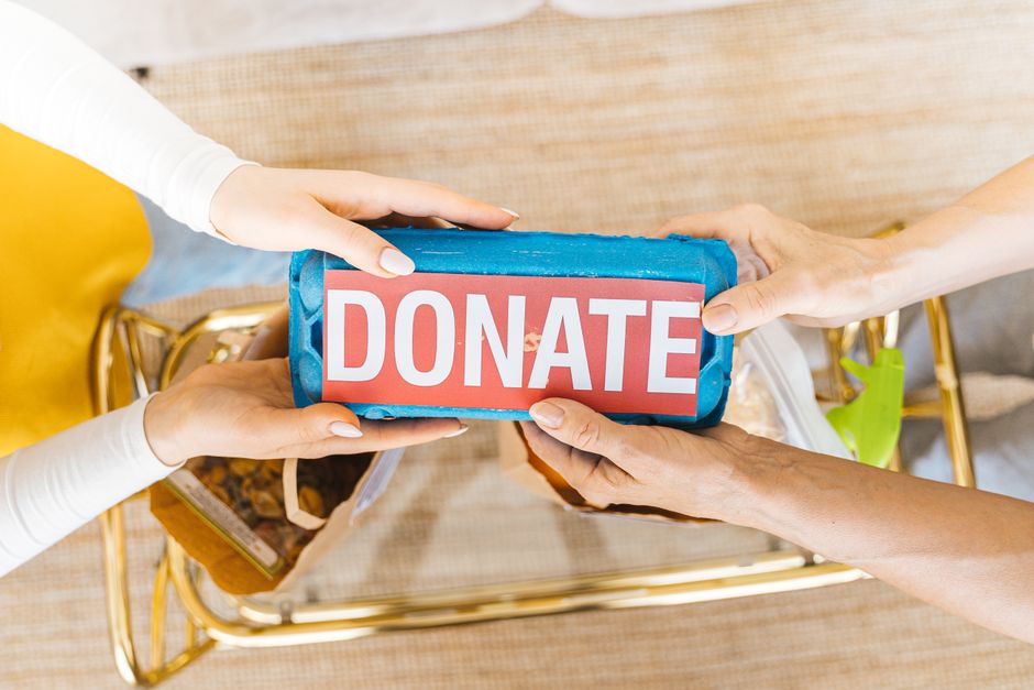 hands giving donation box community