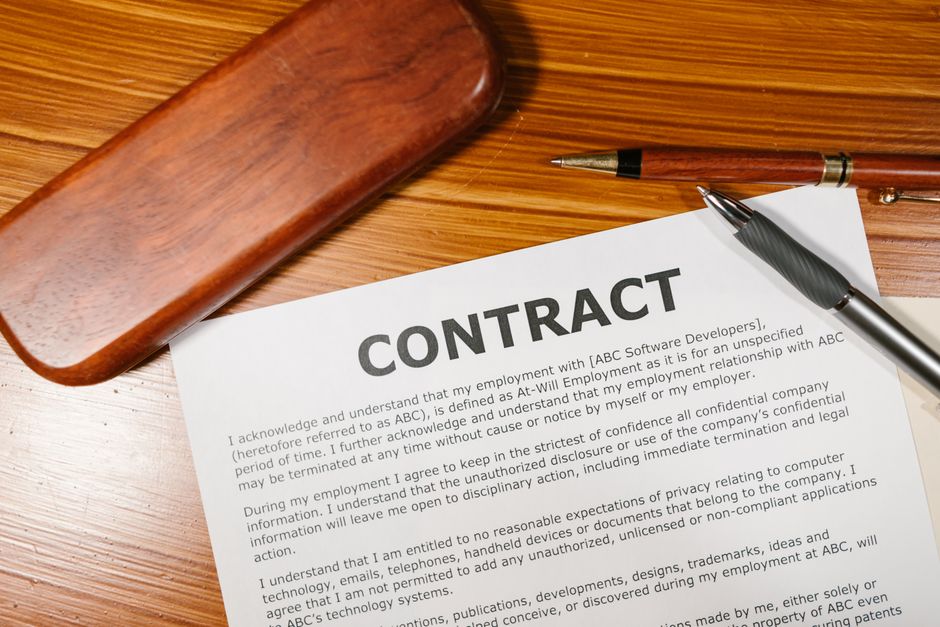contract document with pen and signature