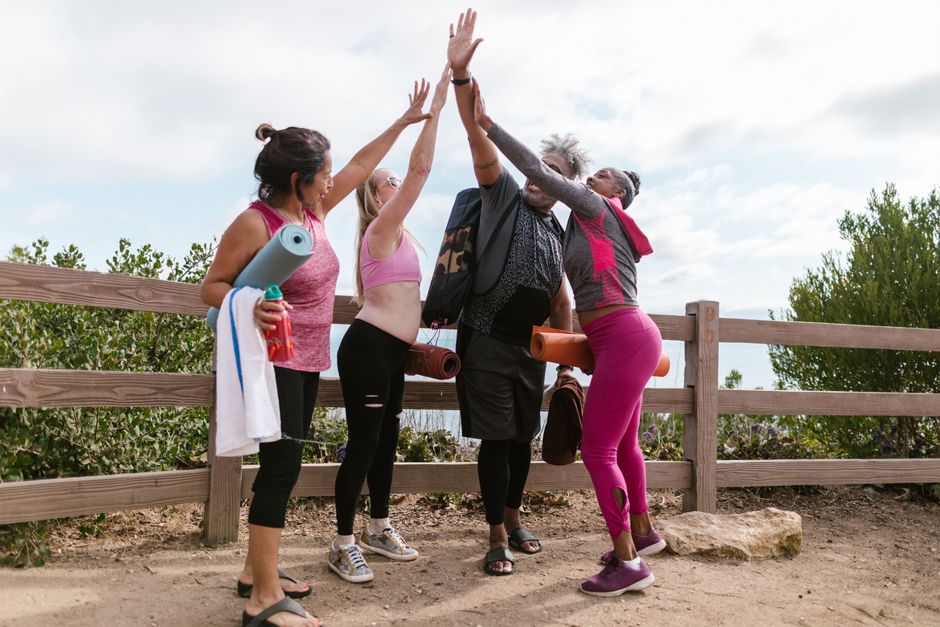 friends exercising together outdoors support