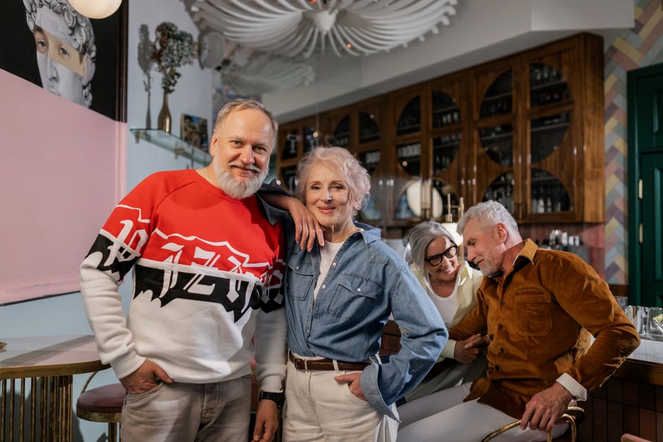 senior friends chatting outdoor cafe