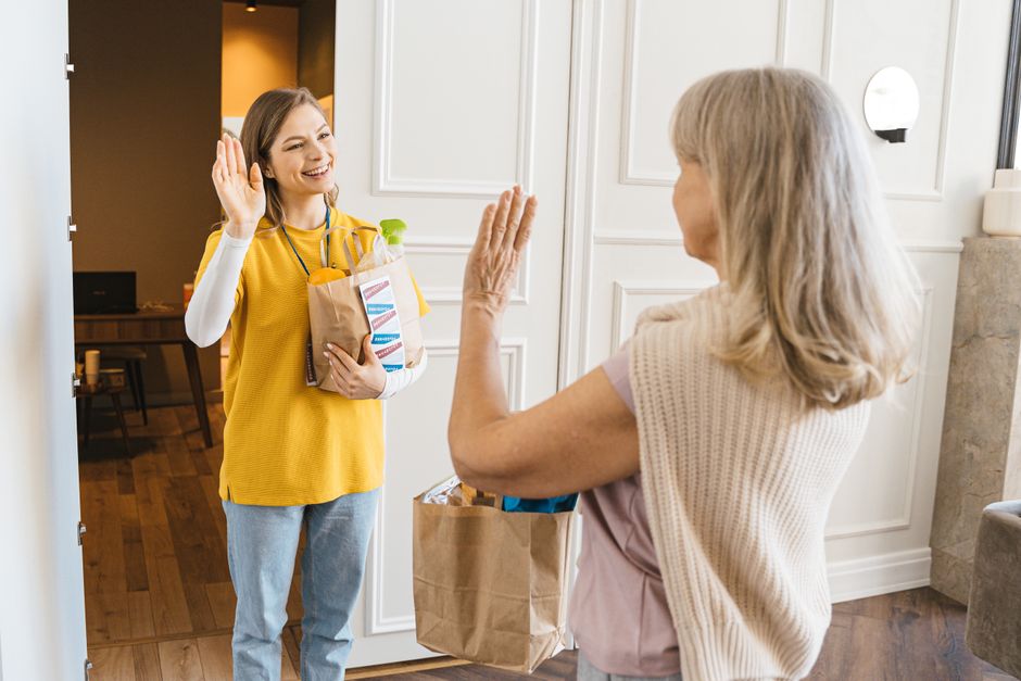 neighbors helping carry groceries