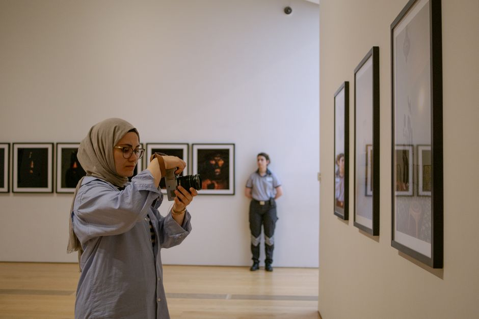 people taking photos museum artwork
