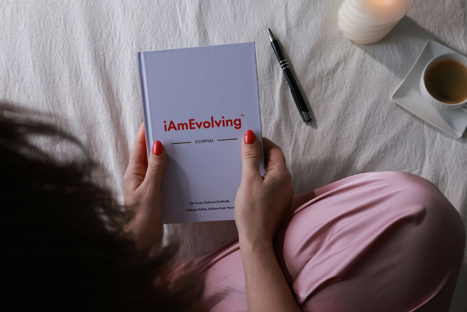 person writing goals journal morning light