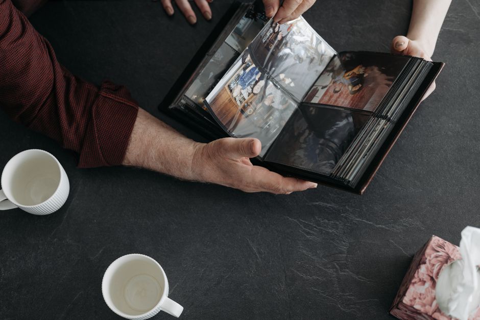 family looking at old photo album together
