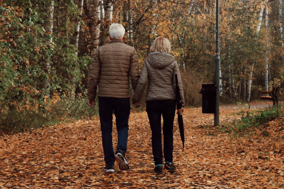 elderly couple walking in park