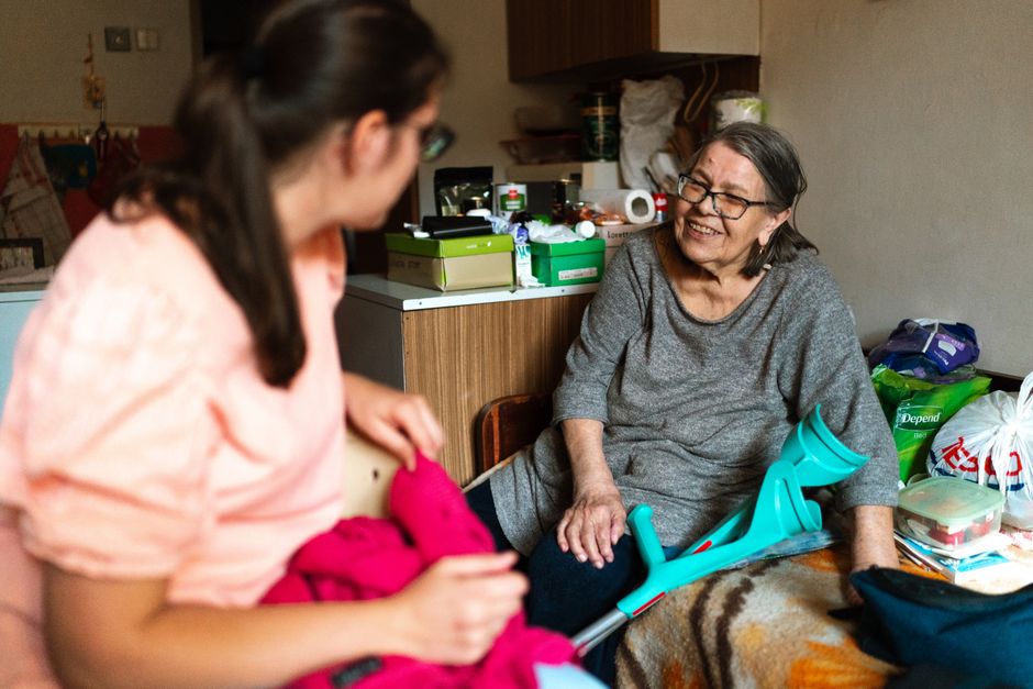 caregiver visiting elderly person at home
