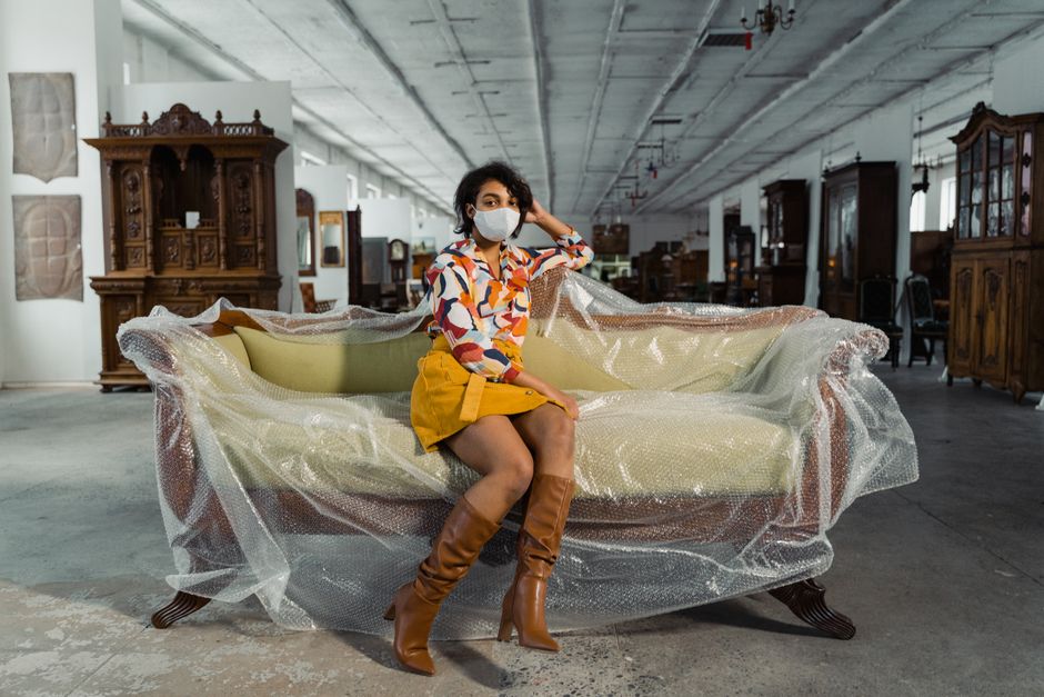 elderly woman testing sofa in furniture store