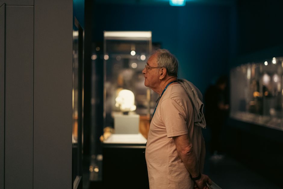 museum docent guiding elderly visitors