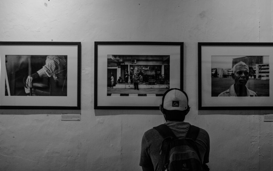 person enjoying art exhibition alone
