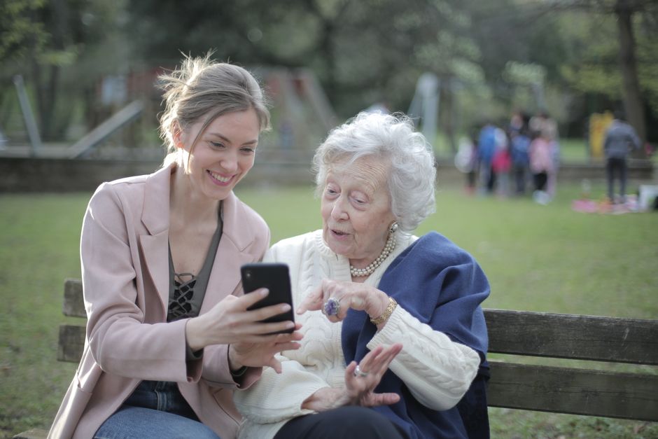 family caregiver and elderly parent smiling
