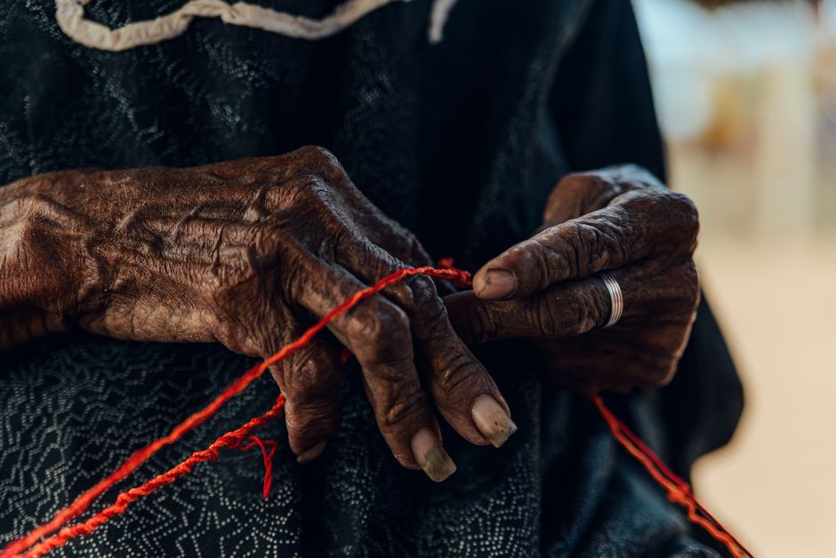 elderly hands knitting close up