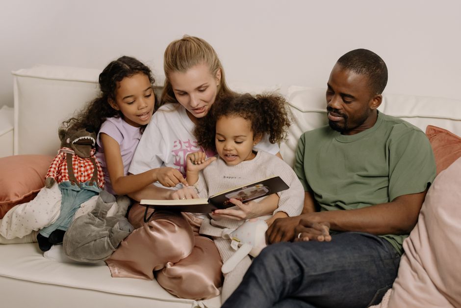 family looking at photo book together