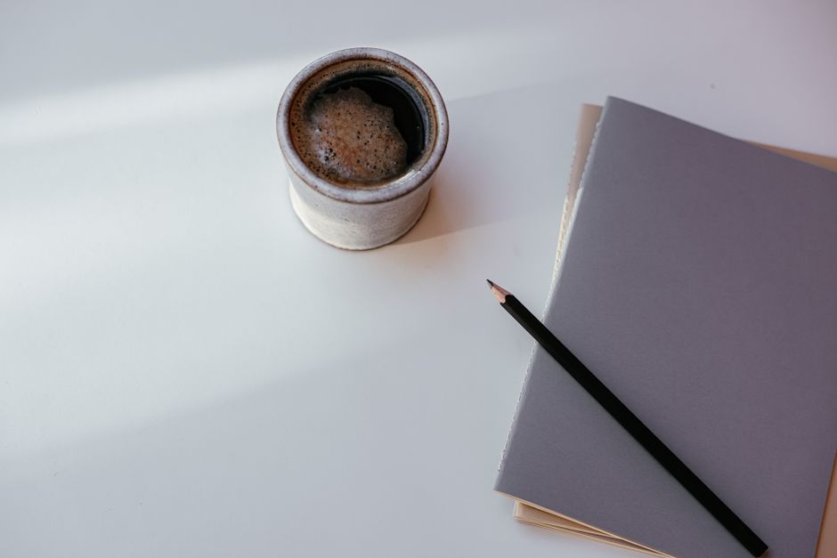 cozy home office desk with notebook and coffee
