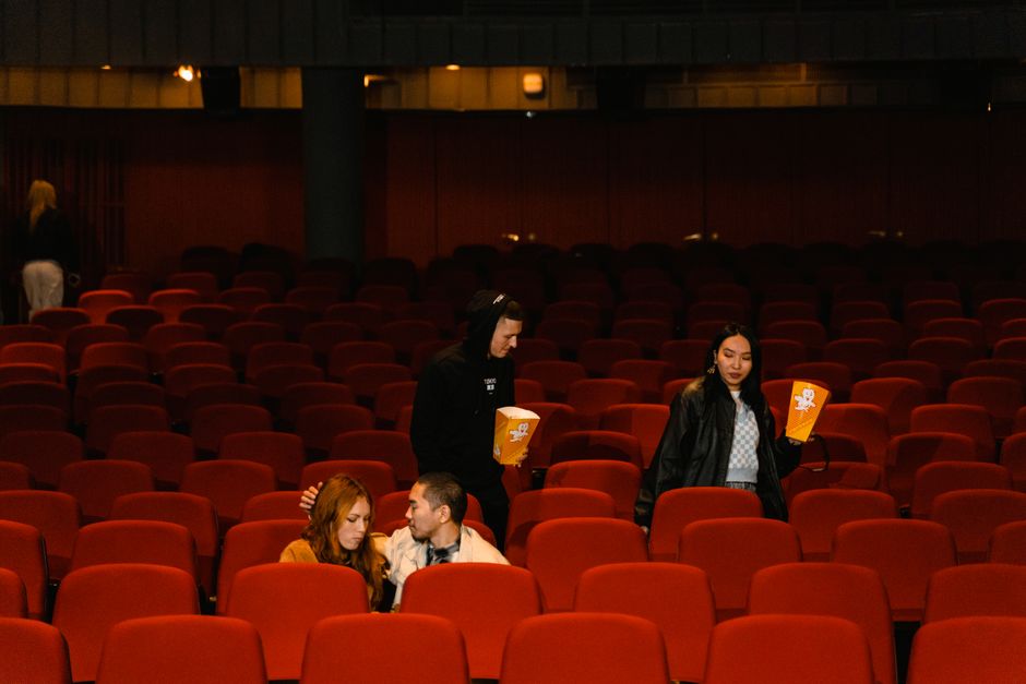 family choosing movie seats cinema